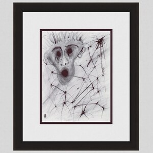 May include: A framed black and white abstract artwork. The artwork features a stylized face with a wide open mouth and dark eyes, surrounded by a web-like pattern. The artwork is framed in a black frame with a white mat.