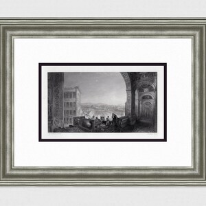 May include: A black and white engraving of a view from a building in Rome, Italy. The engraving shows a cityscape with a bridge in the distance. The engraving is framed in a black frame.