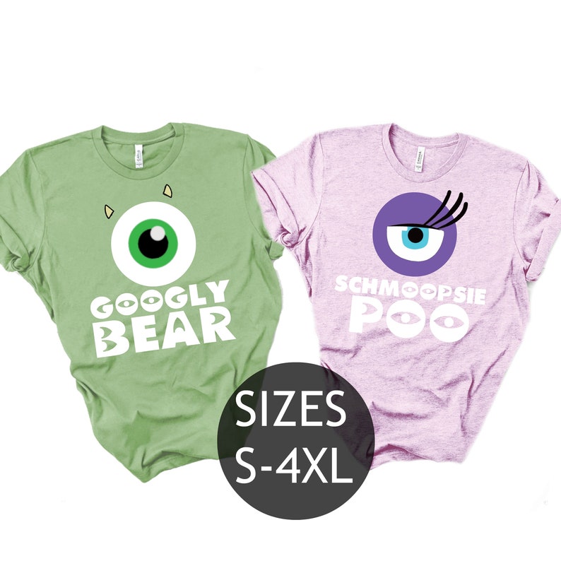 May include: Two t-shirts with a green and a pink color. The green shirt has a white eye with a black pupil and the text "GOOGLY BEAR". The pink shirt has a purple eye with a blue pupil and eyelashes and the text "SCHMOOPSIE POO". The text "SIZES S-4XL" is below the shirts.