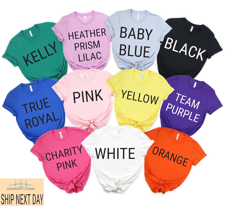 May include: Ten different colored t-shirts with various text printed on them. The colors are Kelly green, Heather Prism Lilac, Baby Blue, Black, True Royal, Pink, Yellow, Team Purple, Charity Pink, and White. The text on the shirts reads: Kelly, Heather Prism Lilac, Baby Blue, Black, True Royal, Pink, Yellow, Team Purple, Charity Pink, and White.