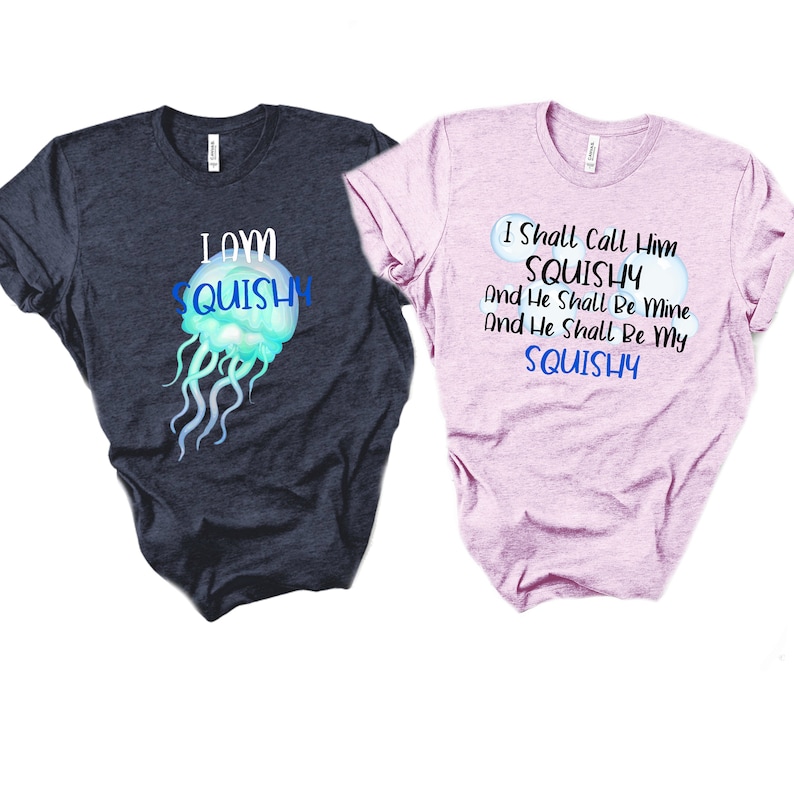 May include: Two t-shirts with a jellyfish graphic and text. The first shirt is dark blue with the text "I own squishy". The second shirt is pink with the text "I shall call him squishy and he shall be mine and he shall be my squishy".