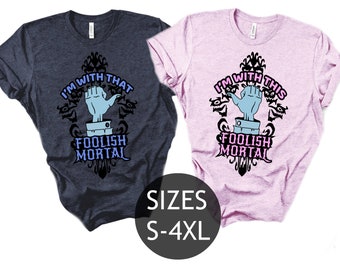 May include: Two t-shirts featuring a graphic design of a hand and the text "I'm with that foolish mortal" and "I'm with this foolish mortal". The shirts are available in sizes S-4XL.