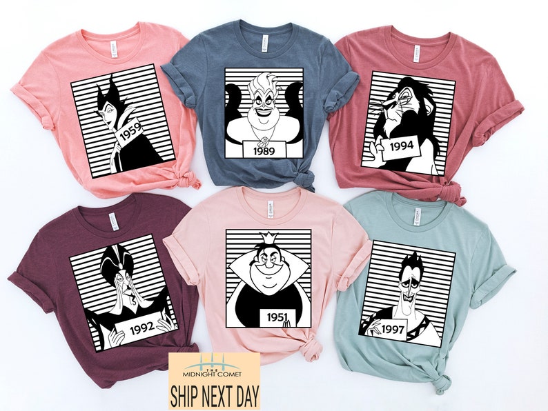 May include: A collection of six colorful t-shirts, each featuring a black and white graphic of a Disney villain with a year on a sign. The shirts are in various colors, including pink, blue, and burgundy.