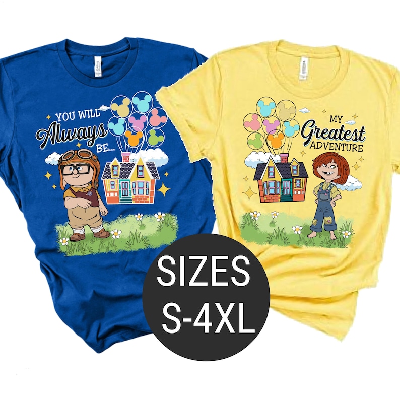 May include: Two t-shirts, one blue and one yellow, featuring cartoon graphics. The blue shirt has the text "YOU WILL Always BE..." and a character with glasses. The yellow shirt says "MY Greatest ADVENTURE". Both shirts have a house with balloons.