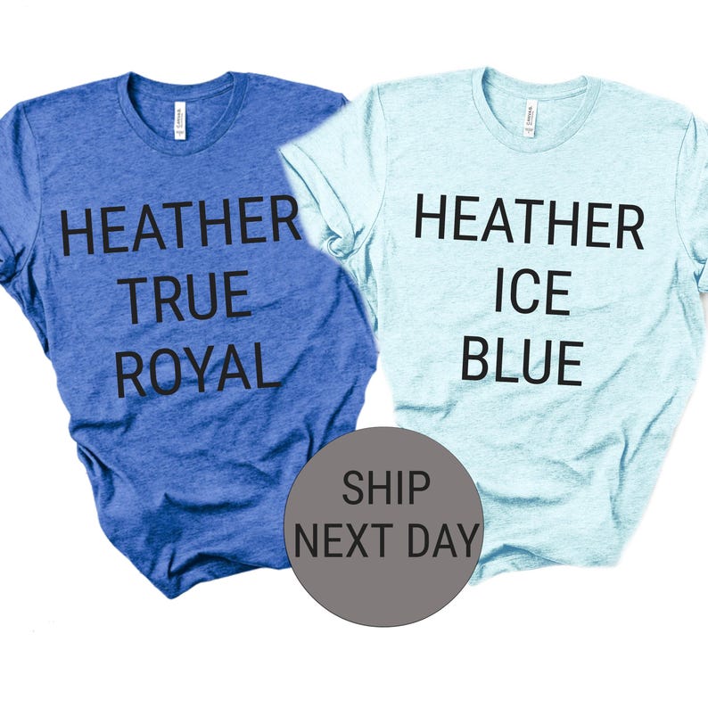 May include: Two heathered t-shirts, one in True Royal blue and the other in Ice Blue. Each shirt has the color name printed in bold black letters. The shirts are displayed on a white background.
