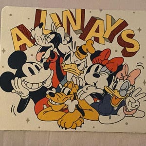 May include: A rectangular card featuring a colorful illustration of Disney characters, including Mickey Mouse, Minnie Mouse, Donald Duck, Daisy Duck, Goofy, and Pluto. The word "ALWAYS" is written across the top in a 3D style.