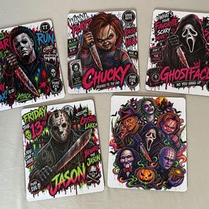 May include: Five rectangular stickers featuring horror movie characters. One shows Michael Myers, one Chucky, one Ghostface, one Jason Voorhees, and one a collage of multiple horror icons including Freddy Krueger and Billy the Puppet with vibrant text.
