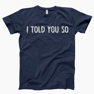 May include: A navy blue t-shirt with the text "I told you so" printed in white.
