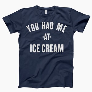 May include: A navy blue t-shirt with white text that reads "You had me at - ice cream".