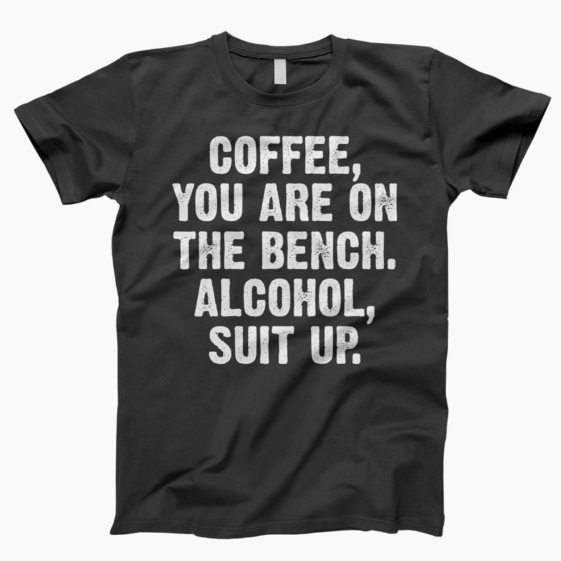 May include: Black t-shirt with white text that reads "Coffee, you are on the bench. Alcohol, suit up."