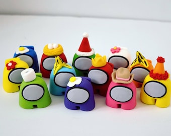 May include: A set of 12 colorful Among Us character figurines, each with a different hat or accessory. The figurines are made of fondant and are perfect for decorating cakes or cupcakes.