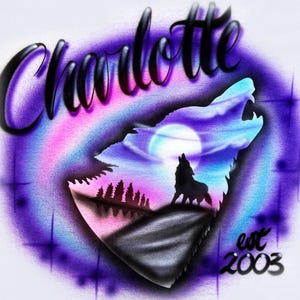 May include: White t-shirt with a colorful airbrushed design. The design features a howling wolf silhouette against a night sky with a full moon, the name "Charlotte", and the text "est 2003". The shirt has a crew neck.