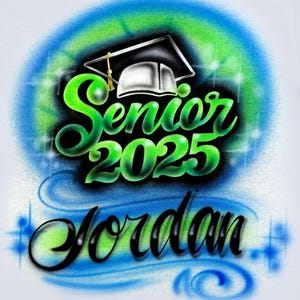 May include: White t-shirt with an airbrushed design of a graduation cap, the words "Senior 2025" and the name "Jordan" in green and blue. The design is surrounded by a blue and green circle.