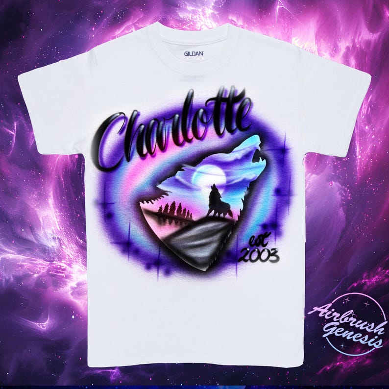 May include: White t-shirt with a colorful airbrushed design. The design features a howling wolf silhouette against a night sky with a full moon, the name "Charlotte", and the text "est 2003". The shirt has a crew neck.