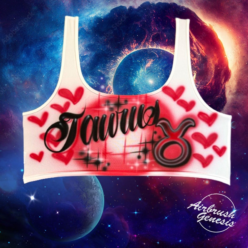May include: White tank top with a red and white airbrushed design featuring the word "Taurus" in black script and the Taurus zodiac symbol in black and red. The design also includes red hearts.