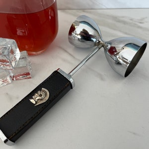 Armor Knight Helmet Vintage Double Stainless Steel Jigger with Black Leather Handle. 1940/1950’s