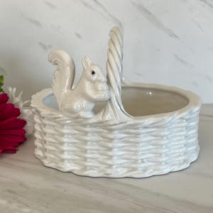 May include: A set of three ceramic mugs with a speckled, matte finish. The mugs are in shades of cream, light gray, and dark gray. Each mug has a simple, minimalist design and a rounded handle.