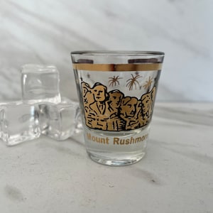 Mount Rushmore Vintage Souvenir Shot with Gold and Black Graphics.