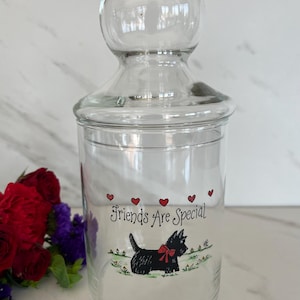 May include: A white-painted wooden sign, distressed for effect, bearing the handwritten text "Welcome to our home". It features a floral design and is ideal for a front door or hallway.