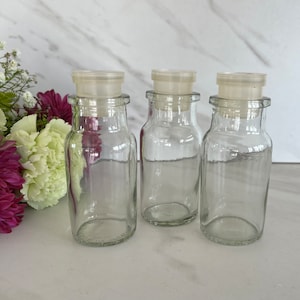 Vintage Clear Glass Spice Jars with Plastic Caps. Set of Three. Embossed on bottom “Bottoms made in Tiawan”. 1960’s