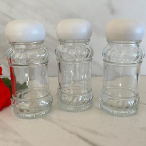 Vintage Clear Glass Spice Jars with Plastic White Bubble Caps and Shaker Tops. Set of Three. Marked on bottom “Made in Tiawan Bottle”