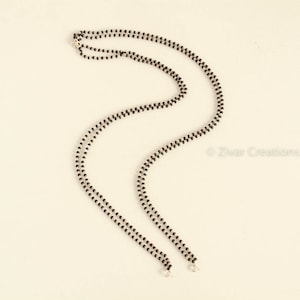 May include: A double-strand black beaded necklace with silver clasps.