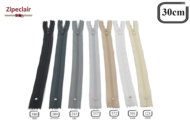 May include: A set of seven 30-inch zipper closures in various colors, including black, gray, light gray, beige, white, and ivory. The zippers are labeled with their corresponding color names and numbers.