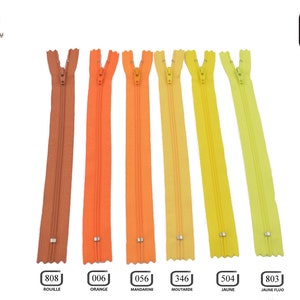 May include: Seven different colors of 30cm zipper tape, including rust, orange, mandarin, mustard, yellow, and two shades of yellow-green. The zipper tape is shown against a white background.