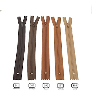 May include: Five different colors of 30-inch zipper tape. The colors are brown, chocolate, tobacco, caramel, and camel. The zipper tape is made of nylon and has a metal slider.