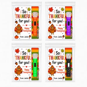 May include: Four clear plastic bags containing a small flashlight with a keychain and a card. The card features a cartoon turkey, autumn leaves, acorns, and the text So THANKFUL for you! Happy Thanksgiving! From: Jackie. Flashlights are orange, purple, green, and black.