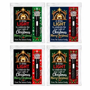 May include: Four clear plastic pouches containing a black keychain flashlight and a card featuring a nativity scene. The text reads: A little LIGHT to celebrate the true Light of Christmas Merry Christmas! From: The Jackson Family.