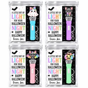 May include: Four clear plastic bags containing small flashlights with keychains. Each bag features a card with the text A LITTLE BIT OF LIGHT FOR YOUR HALLOWEEN NIGHT HAPPY HALLOWEEN! From: Jen. The cards show a ghost, cat, bat, or pumpkin.