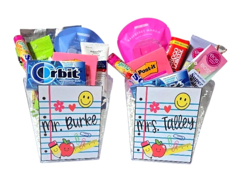May include: Two gift baskets filled with various items, including Orbit gum, face masks, and Post-it notes. Each basket has a notepad design with a smiling face, apple, pencil, and the names "Mr. Burke" and "Mrs. Talley."