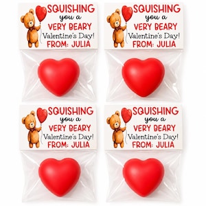 May include: Four clear plastic bags each containing a red heart-shaped foam stress toy. Attached to the top of each bag is a white card featuring a brown teddy bear holding a red balloon and the text SQUISHING you a VERY BEARY Valentine's Day! FROM: JULIA.