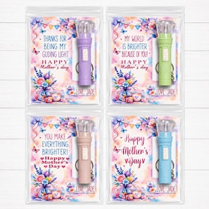 May include: Four colorful LED flashlights on keychains, each in a clear plastic bag with a decorative card. The cards have floral designs, butterflies, and text that reads "Happy Mother's Day" and "Love, Jade."