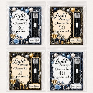 May include: Four clear plastic bags each containing a black LED flashlight keychain and a decorative card. The cards feature the text Light 'em up Cheers to 30, 50, 21, or 40 years, champagne glasses, balloons, and a From: name tag for personalization.