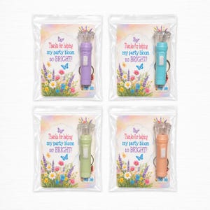 May include: Four small flashlights in various colours: purple, teal, green, and peach. Each flashlight is packaged in a clear plastic bag with a floral-themed card that reads "Thanks for helping my party bloom so BRIGHT!"