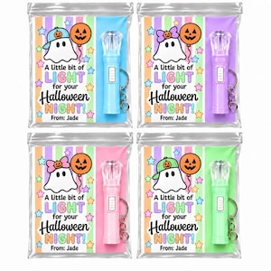 May include: Four clear plastic favor bags containing a small flashlight keychain and a card with a ghost illustration, a pumpkin balloon, and the text A little bit of LIGHT for your Halloween NIGHT! From: Jade. The flashlights are blue, purple, pink, and green.