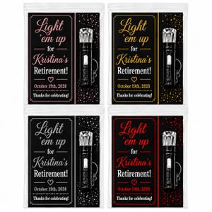 May include: Four clear plastic bags containing black flashlights with keychains. Each bag features a card with the text Light 'em up for Kristina's Retirement! October 19th, 2026. Thanks for celebrating! The cards have pink, gold, white, or red accents.