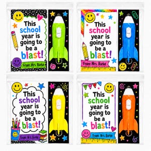 May include: Four clear plastic bags containing school gift sets. Each set includes a card with the text This school year is going to be a blast! From: Mrs. Burke and a plastic rocket-shaped toy in lime green, blue, yellow, or orange.