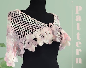May include: A pink and white crocheted shawl with a delicate floral design. The shawl is displayed on a black mannequin.