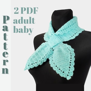 May include: A light blue crocheted scarf with a delicate lace pattern. The scarf is tied in a bow and displayed on a black mannequin. The text "2 PDF Pattern adult baby" is visible in the image.