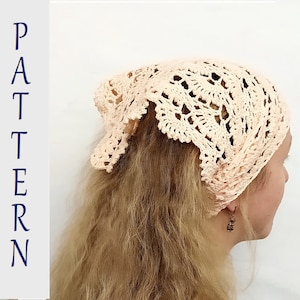 May include: A delicate crocheted headband in a light peach color. The headband is made with a lacy pattern and has a soft, feminine look.