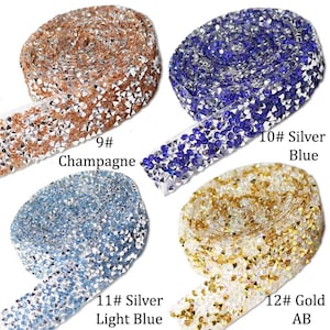 May include: Four rolls of rhinestone trim in different colors: champagne, silver blue, silver light blue, and gold AB. Each roll is labeled with a number and color name.