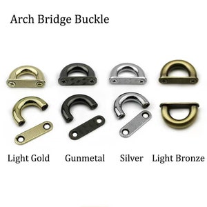 Könnte beinhalten: Bogenbrücke-Schnalle in den Ausführungen Hellgold, Gunmetal, Silber und Hellbronze. Jede Schnalle ist ein D-Ring mit einer flachen, rechteckigen Platte.