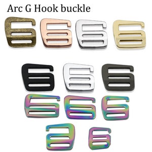 May include: A set of ten Arc G Hook buckles in various colors, including bronze, rose gold, silver, black, and rainbow.