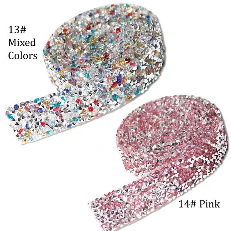 May include: Two rolls of rhinestone trim, one with mixed colors and one in pink. The trim is silver with clear rhinestones and is approximately 1 inch wide.