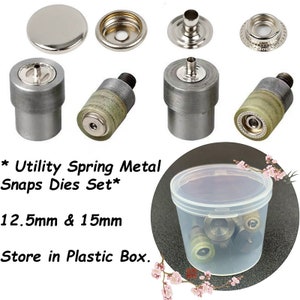May include: A collection of metal snap dies, featuring various components and tools. The image displays several silver-coloured snaps and dies, alongside a clear plastic container holding extra pieces. Text on the image reads "Utility Spring Metal Snaps Dies Set" and measurements of 12.5mm & 15mm.