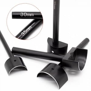 May include: Black leathercraft tools with semi-circular cutting heads. The tools have long handles and are labeled with measurements of 30mm and 35mm. The tools are designed for cutting leather.
