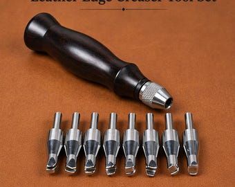 May include: Leather edge creaser tool set with a dark wooden handle and silver metal creasing tips. The set includes a handle and eight interchangeable creasing tips. The text "Leather Edge Creaser Tool Set" is at the top of the image.